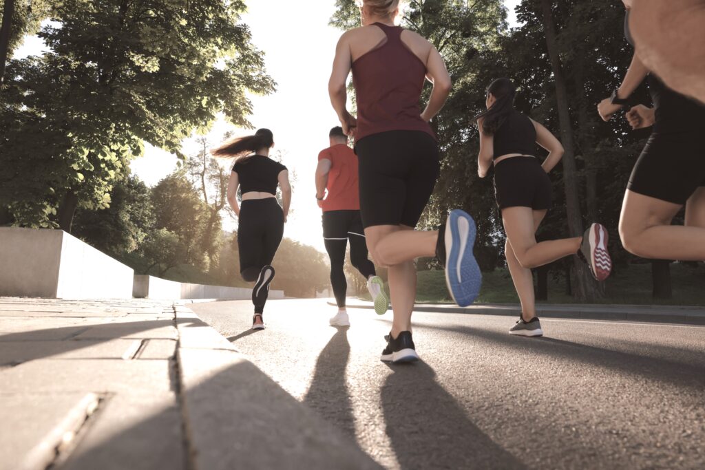 group,of,people,running,outdoors,on,sunny,day,,back,view